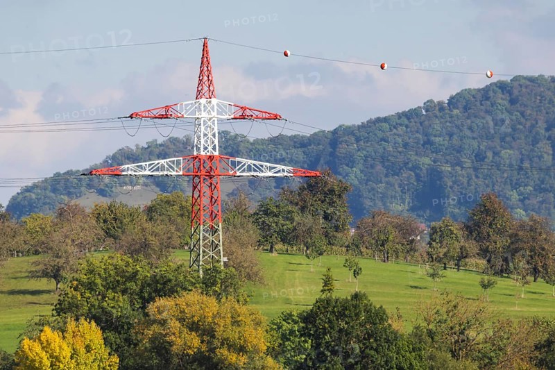High-voltage pylon with signalling paint in front of the landscape of the Swabian Alb. Kirchheim unter Teck, Baden-Württemberg, Germany