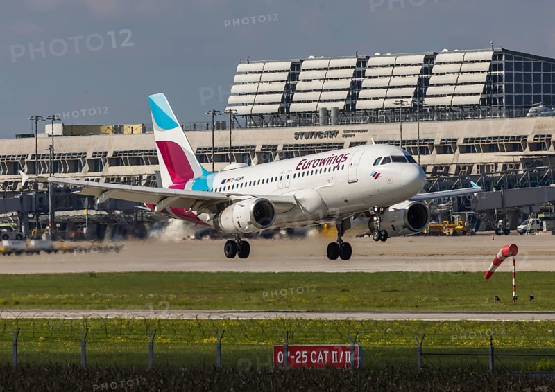Flight operations at Stuttgart Airport with terminal. Aircraft on landing. Aircraft registration number: D-AGWM, Eurowings, Airbus A319-100