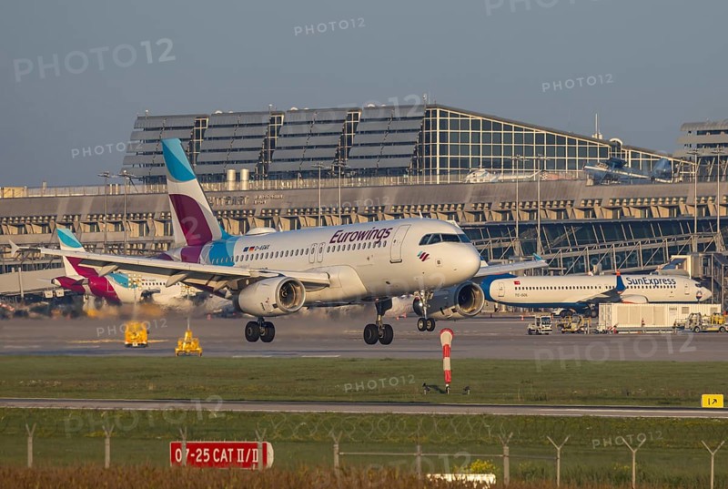 Flight operations at Stuttgart Airport with terminal. Aircraft on landing. Aircraft registration number: D-GAWX, EUROWINGS, AIRBUS A319-100, Stuttgart, Baden-Württemberg, Germany