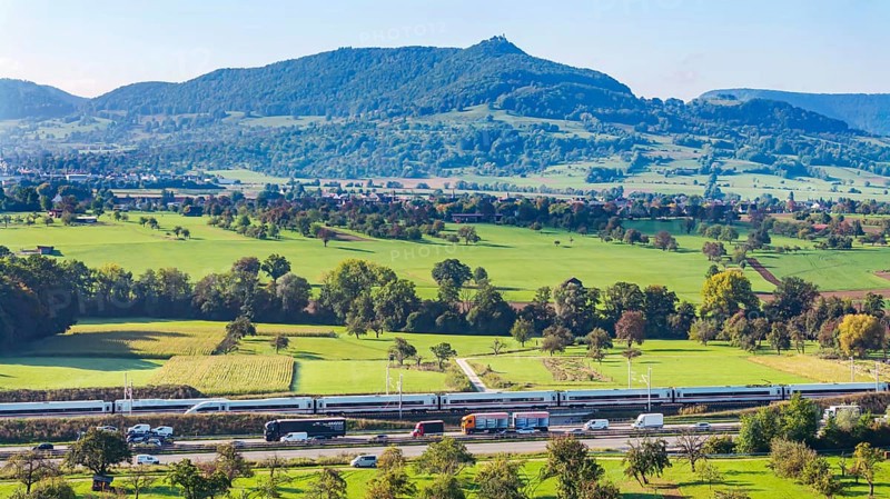 Landscape in the foothills of the Swabian Alb with the new Deutsche Bahn AG railway line from Stuttgart to Ulm. Two ICE trains meeting. Kirchheim unter Teck, Baden-Württemberg, Germany