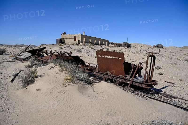 Wagon of an old narrow-gauge railway in the desert sand, Pomona, restricted diamond area, near Lüderitz, Karas region, Namibia