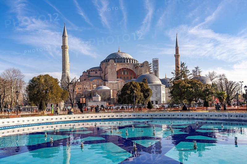 Fountain in Sultan Ahmet Park and the present-day mosque Hagia Sophia or Church of St Sophia, former Byzantine church and museum in Istanbul, Turkey