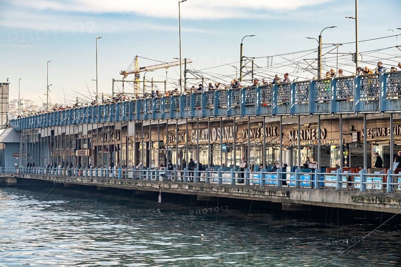 Anglers and restaurants on the Galata Bridge in Istanbul, Turkey