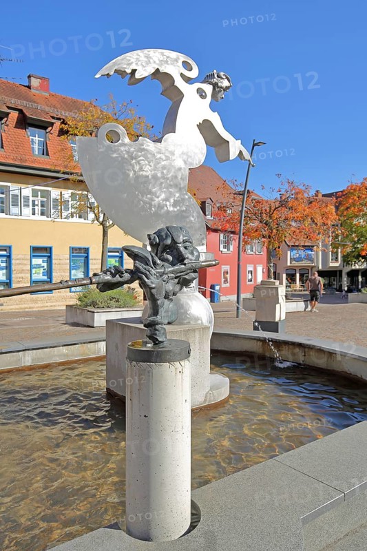 Sculpture guardian angel Angel by Jürgen Goertz and Flute Player by Karel Fron, 2008, modern art, water basin, fountain, shiny angel with index finger, silver, aluminium, bizarre head with flute, torso, bronze sculpture, water basin, fountain gallery, Adenauerplatz, Wiesloch, Baden-Württemberg, Germany