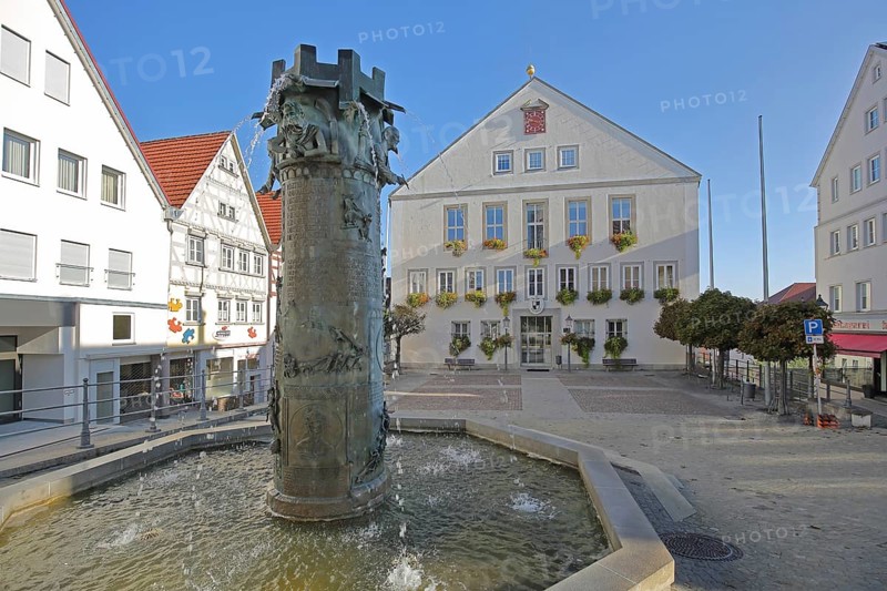 Town hall built in 1958 and town hall fountain with reliefs and figures by Klaus Ringwald 1998, market square, Hechingen, Swabian Alb, Baden-Württemberg, Germany