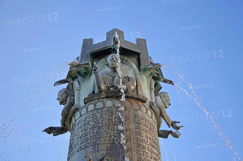 Town hall fountain by Klaus Ringwald 1998, bronze sculptures, reliefs, figures and text on the history of the town, inscription, water features, detail, cut-out, market square, Hechingen, Swabian Alb, Baden-Württemberg, Germany