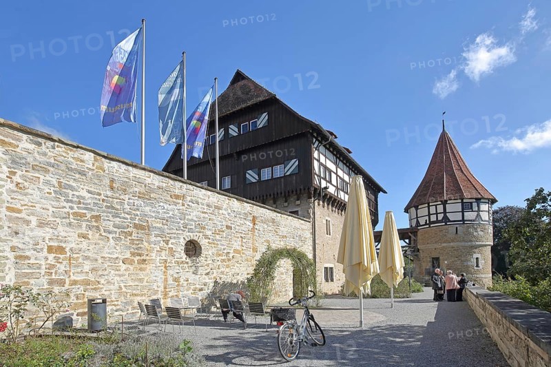 Water tower of the medieval Zollern castle built around 1255, half-timbered house, flags, stone wall, castle, Balingen, Swabian Alb, Baden-Württemberg, Germany