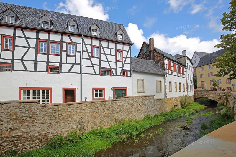 Historic half-timbered house Alte Mälzerei on the Erft stream and stone arch bridge, Bad Münstereifel, Ahrgebirge, Eifel, North Rhine-Westphalia, Germany