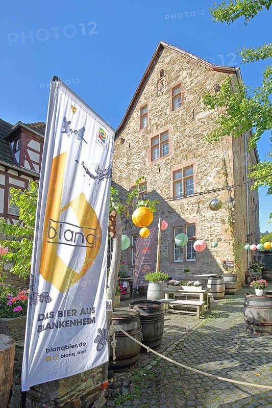 Banner with beer brand, lanterns and courtyard with wine barrels, flag, inscription, Blankenheim, beer brand, advertising, decoration, Steinfelderhof, Bad Münstereifel, Ahrgebirge, Eifel, North Rhine-Westphalia, Germany