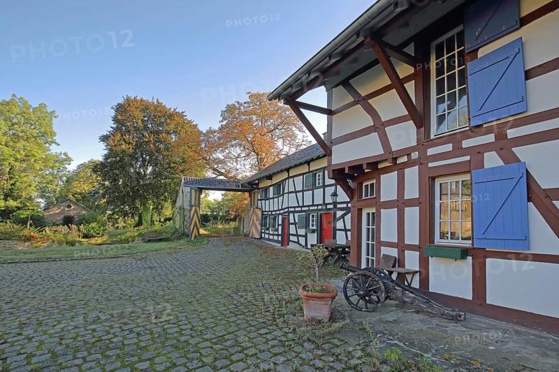 Half-timbered house with colourful shutters and entrance, built 14th century, inner courtyard, archway, moated castle, Kleeburg, Weidesheim, Euskirchen, Vordereifel, Eifel, North Rhine-Westphalia, Germany