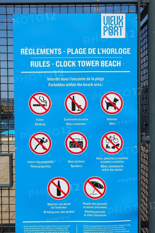 Posted rules sign with pictograms showing various restrictions at Clock Tower Beach, Old Port of Montreal, Quebec, Canada