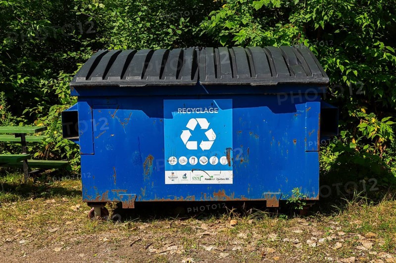 Blue metal with black plastic lids industrial size recycling bin for depositing glass, metal and plastic containers in, Ile des Moulins, Old Terrebonne, Quebec, Canada