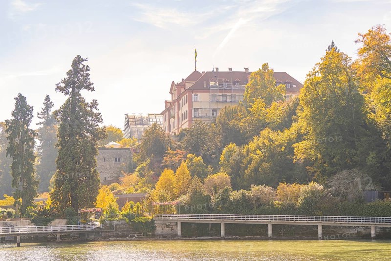 Castle on a wooded hill with autumnal trees, Mainau Island, Lake Constance, Germany