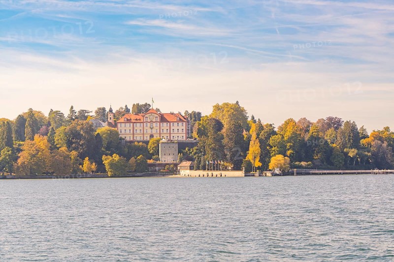 Sweeping view of the castle and autumnal forest by the lake, Mainau Island, Lake Constance, Germany