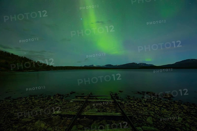 Magical northern lights over Lake Torneträsk at the boathouse
