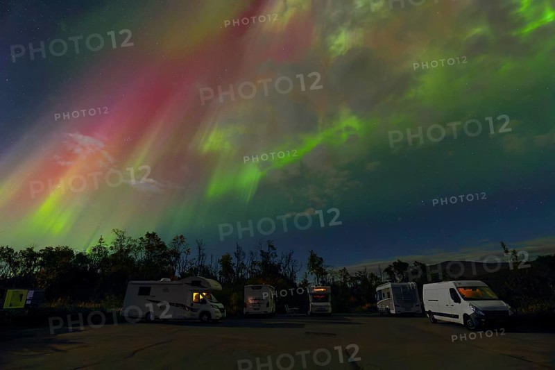 Where heaven and earth shine - campers under the dancing Northern Lights in Scandinavia