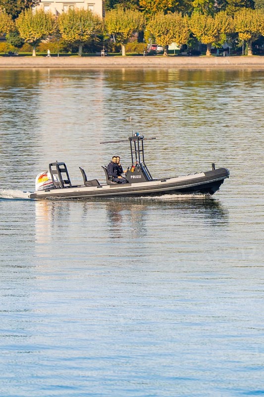 Small police motorboat on calm water with two people on board, Constance, Lake Constance, Germany