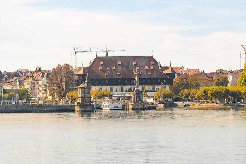 Historic riverside building with autumnal trees and peaceful atmosphere, Constance, Lake Constance, Germany