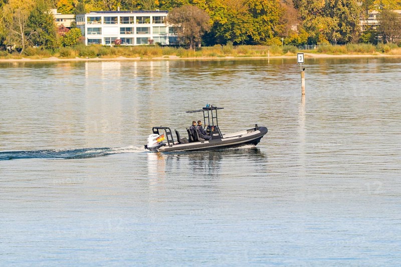 Fast police motorboat with two passengers travelling across the calm waters of a lake, Constance, Lake Constance, Germany