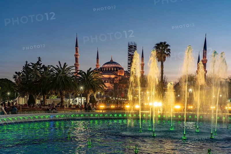 Fountain in Sultan Ahmet Park and the Blue Mosque or Sultan Ahmed Mosque at dusk, Istanbul, Turkey
