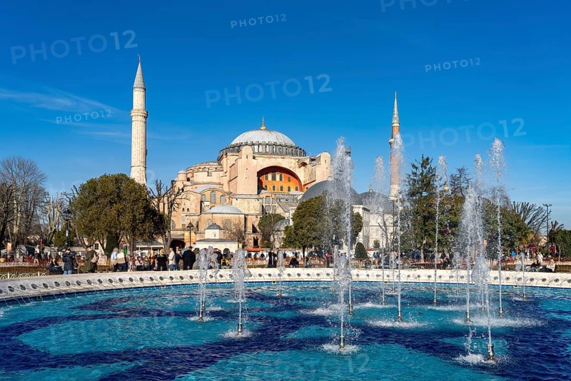 Fountain in Sultan Ahmet Park and the present-day mosque Hagia Sophia or Church of St Sophia, former Byzantine church and museum in Istanbul, Turkey