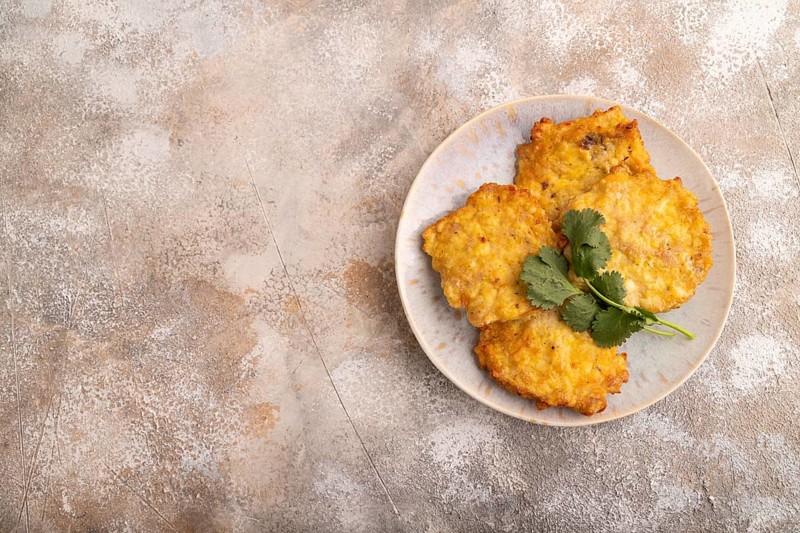 Fried crispy Chicken pancakes on brown concrete background. top view, flat lay, copy space