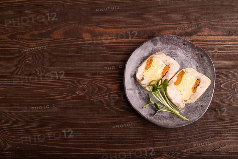 Chicken, egg and dried apricot meatloaf, microgreen on brown wooden. Diet, healthy eating. top view, copy space