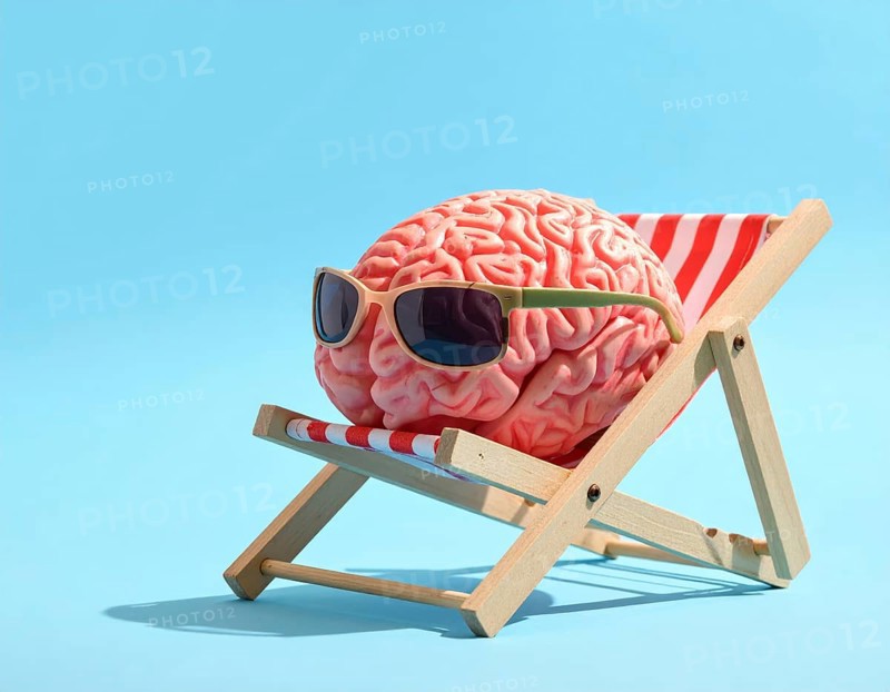 Brain relaxes on a sunbed under the summer sun, placed on a flat surface, symbol for mental health, AI generated