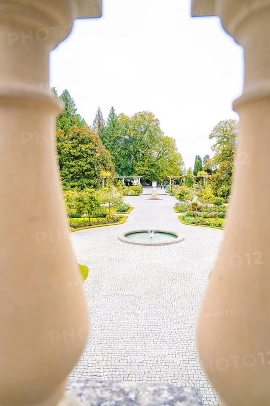 View of manicured path with fountain through decorative columns, Mainau flower island, Lake Constance, Germany