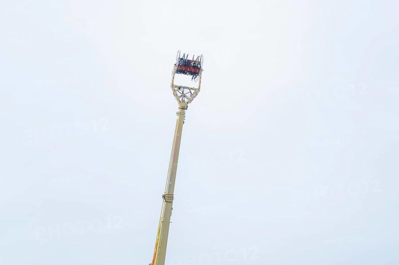 An attraction with people and a wide view of the sky, Cannstatter Wasen fair, Stuttgart, Germany