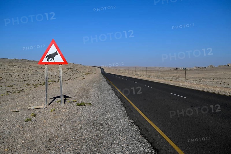 Sign warning of brown hyenas or beach wolves (Parahyaena brunnea) near Lüderitz, Karas Region, Namibia