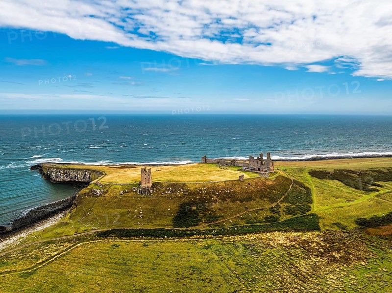 Dunstanburgh Castle from a drone, Northumberland Coast, England, United Kingdom