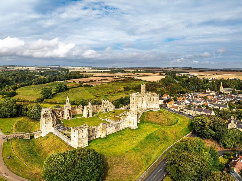 Warkworth Castle over River Coquet from a drone, Warkworth, Northumberland, England, United Kingdom