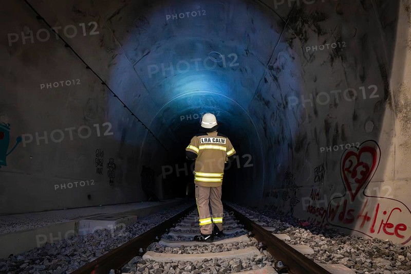 Firefighter in protective clothing enters illuminated tunnel, fire drill in the new tunnel of the Hermann Hesse railway, Ostelsheim, Calw district, Germany