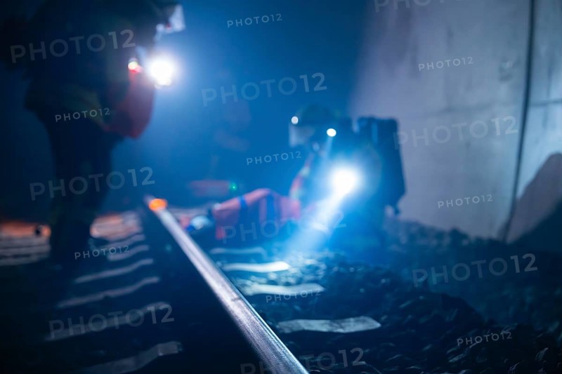 Firefighters use torches on tracks in a tunnel, firefighting exercise in the new construction tunnel of the Hermann Hesse railway, Ostelsheim, Calw district, Germany