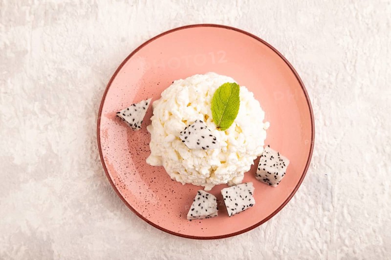 White ?ottage cheese, Curd, with Pithaya on gray concrete background, top view, flat lay, close up