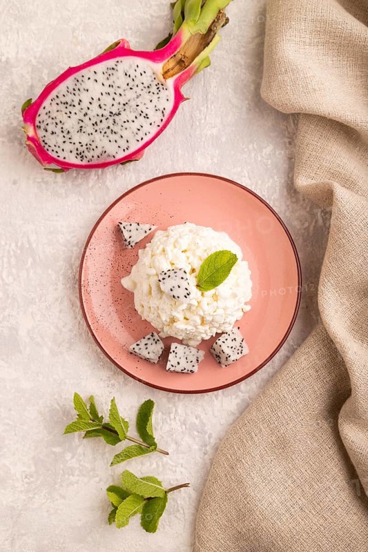 White ?ottage cheese, Curd, with Pithaya on gray concrete background and linen textile, top view, flat lay, close up