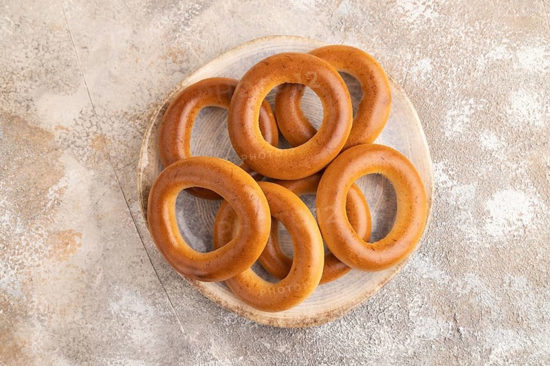 Homemade Ring Bagel on brown concrete background. top view, flat lay, copy space