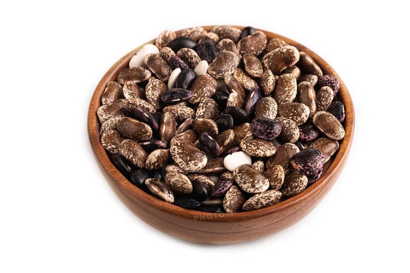 Wooden bowl with Kidney beans isolated on white background, side view, close up, minimalism