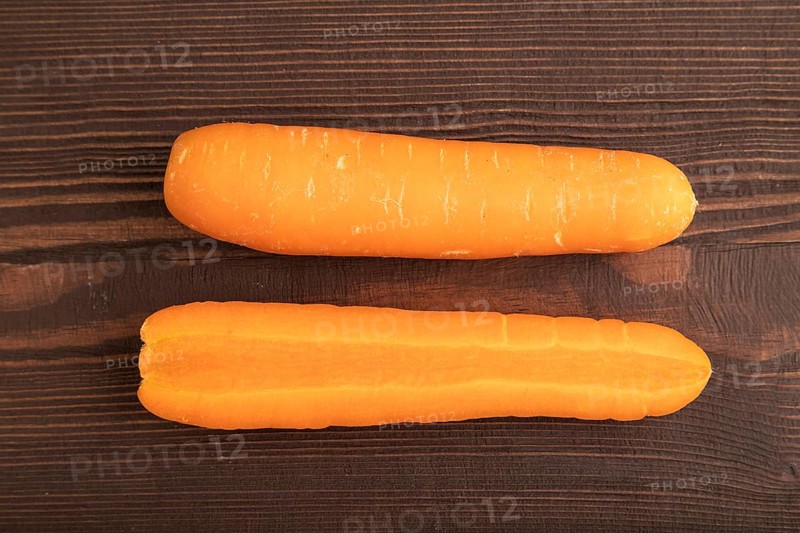 Orange Carrot on brown wooden background. Top view, close up, flat lay. healthy food, vegetable, minimalism