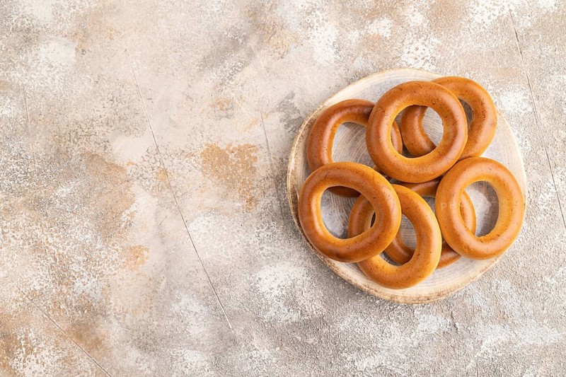 Homemade Ring Bagel on brown concrete background. top view, flat lay, copy space