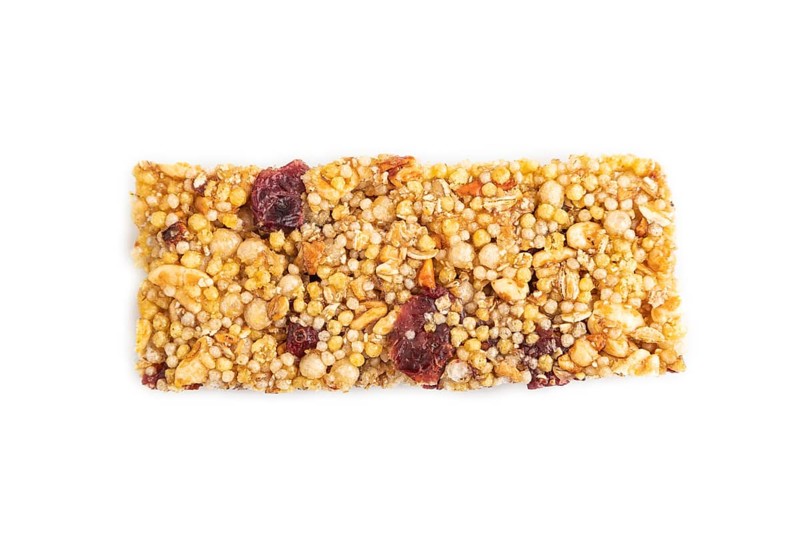 Granola bar with, caramel, nuts, flakes isolated on white background. Top view, flat lay, close up