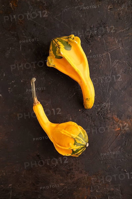 Two decorative orange Pumpkins on black concrete background, top view, flat lay, copy space, minimalism