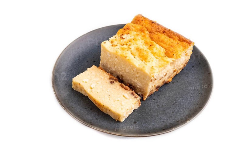 ?ottage cheese ?asserole, Curd cake, with dried apricots and raisins Isolated on white background, side view, close up, minimalism