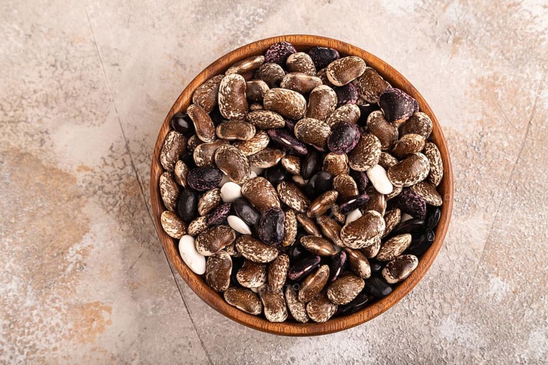 Wooden bowl with Kidney beans on brown concrete background, top view, flat lay, copy space, minimalism