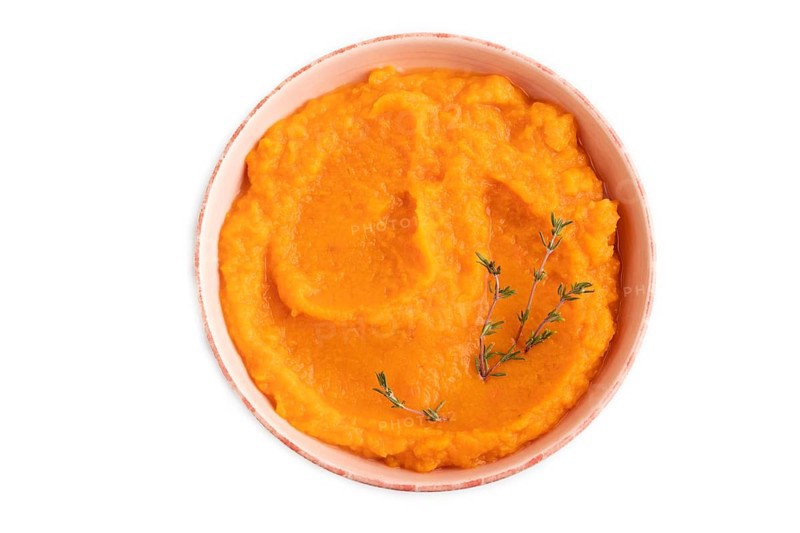 Sweet potato porridge in ceramic bowl isolated on white background. Diet, healthy eating concept. top view, flat lay, close up