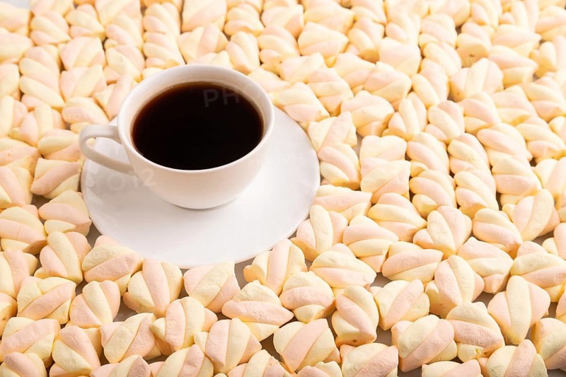 Cup of coffee on Orange and pink marshmallow background, side view, copy space, minimalism