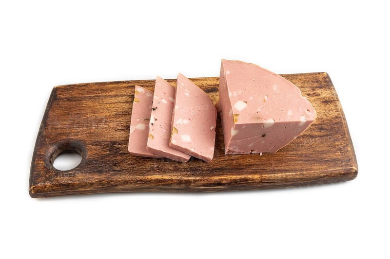 Mortadella sausage on wooden cutting board with pepper and herbs isolated on white background. Side view, close up