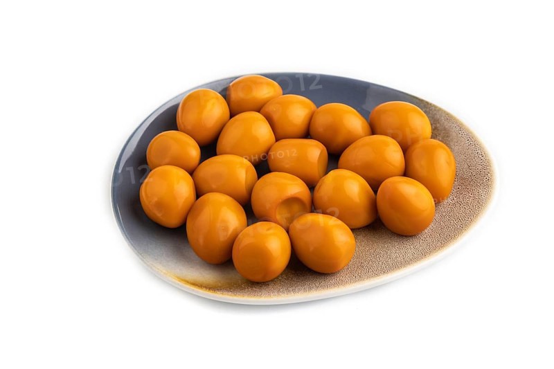 Pile of Smoked Quail eggs isolated on white background. side view, close up