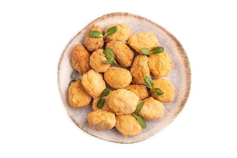 Fried crispy Chicken Nuggets with ketchup, microgreen isolated on white background. top view, flat lay, close up